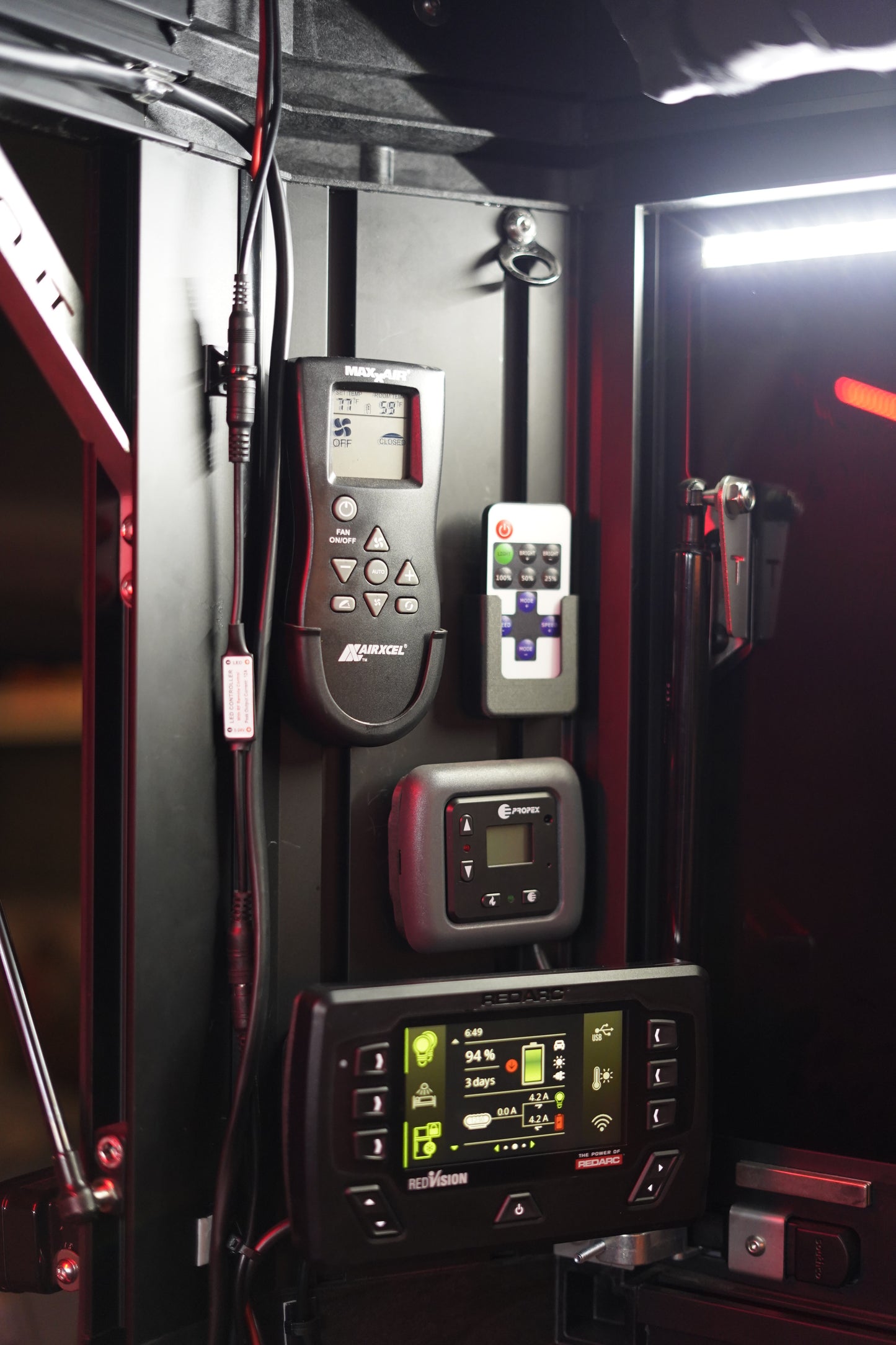 Control panel with digital display and buttons, featuring Propex branding, on a vehicle dashboard.